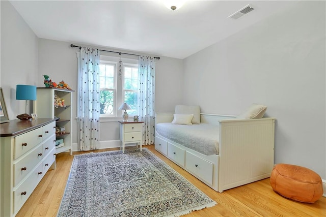 bedroom featuring light wood-style flooring and visible vents