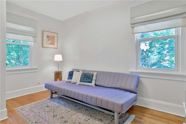 sitting room with light wood finished floors and baseboards