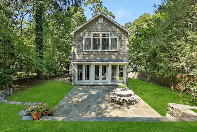 back of house with french doors, a patio, fence, a yard, and an outdoor structure