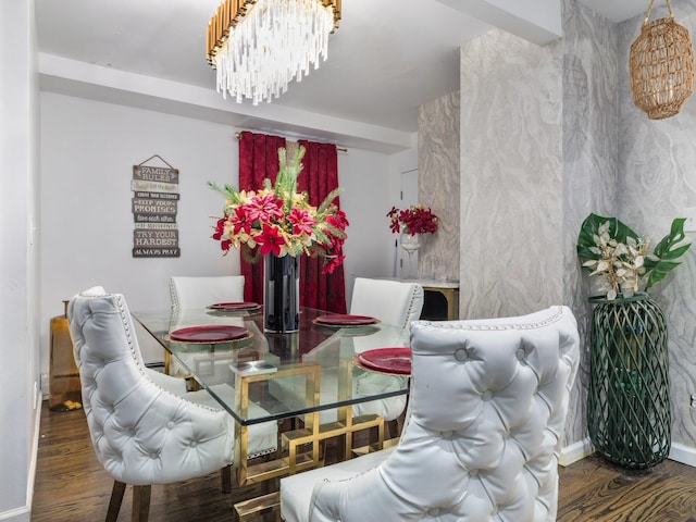 dining area featuring a notable chandelier and dark hardwood / wood-style flooring