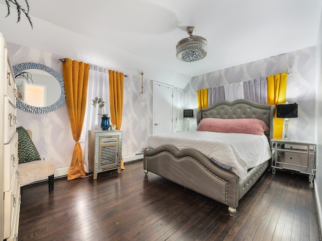 bedroom featuring lofted ceiling, dark hardwood / wood-style floors, and a baseboard heating unit