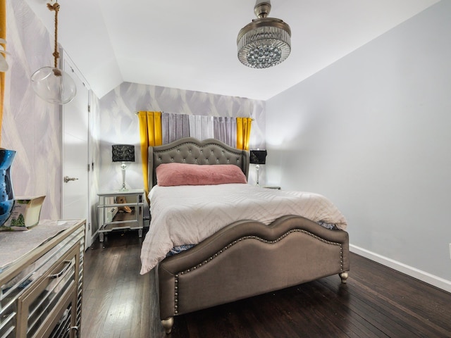 bedroom with dark hardwood / wood-style floors and lofted ceiling