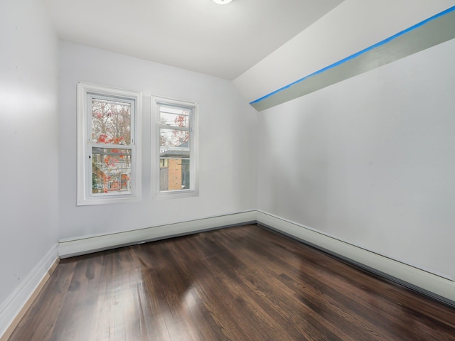 bonus room featuring dark hardwood / wood-style flooring, a baseboard radiator, and vaulted ceiling