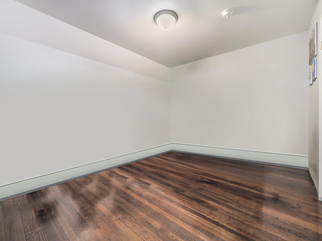 empty room with dark hardwood / wood-style floors