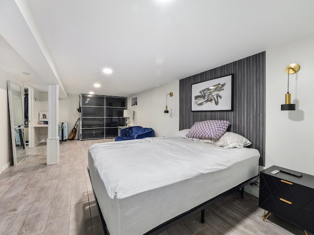 bedroom featuring radiator and light hardwood / wood-style flooring