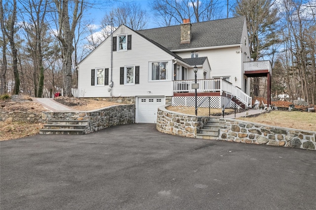 view of front of house featuring a deck and a garage