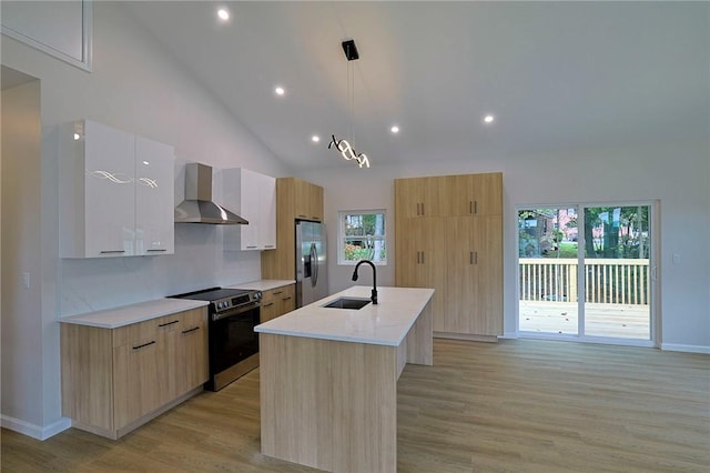 kitchen featuring sink, wall chimney exhaust hood, stainless steel fridge with ice dispenser, electric stove, and a kitchen island with sink