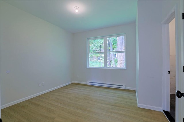 spare room featuring light hardwood / wood-style flooring and a baseboard radiator