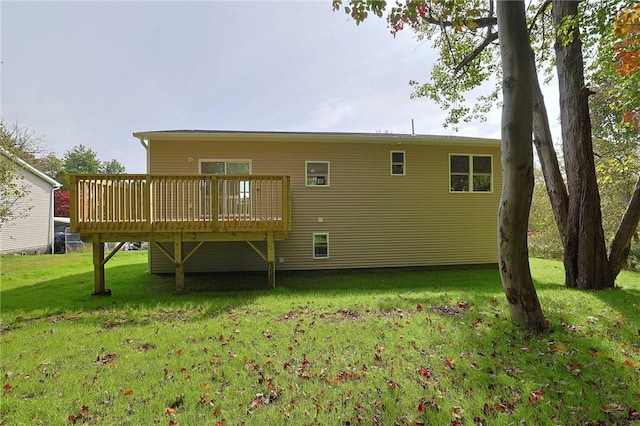 back of property featuring a lawn and a deck