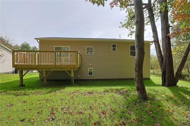 back of house with a lawn and a wooden deck