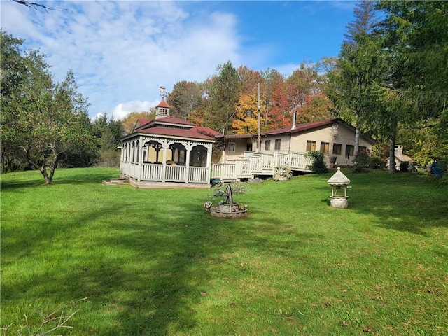 back of house featuring a gazebo and a yard