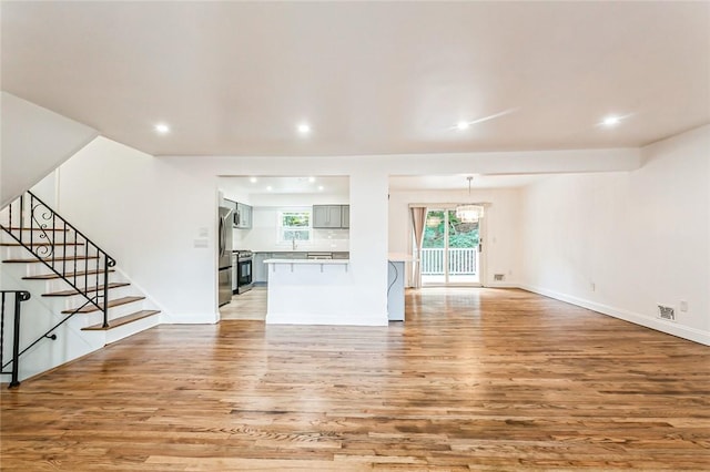 unfurnished living room featuring light wood-type flooring