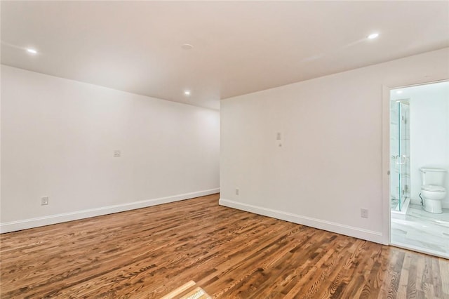 unfurnished room featuring hardwood / wood-style flooring
