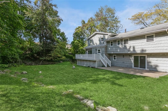 rear view of property with a lawn and a patio