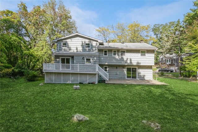 rear view of property with a patio, a yard, and a deck