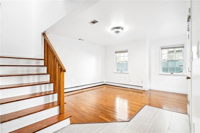 interior space with light hardwood / wood-style floors and a baseboard radiator