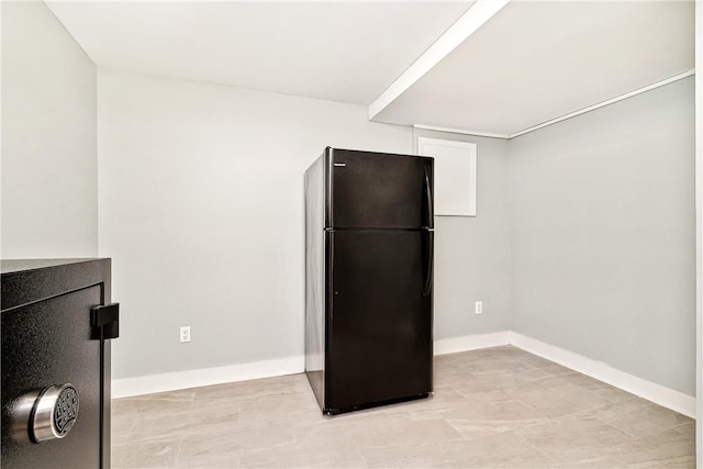 kitchen featuring black refrigerator