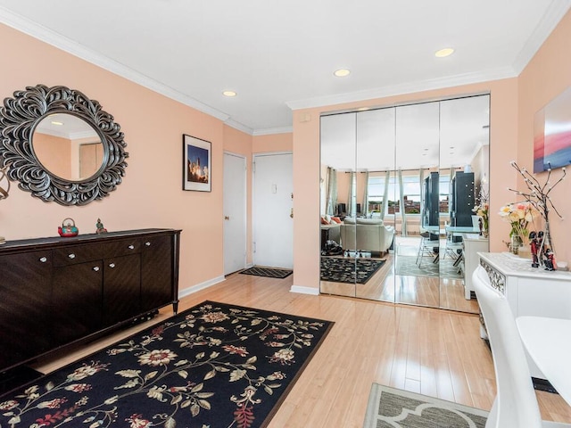 foyer featuring light hardwood / wood-style floors and ornamental molding