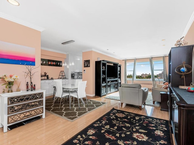 living room featuring a wall of windows, crown molding, and light wood-type flooring