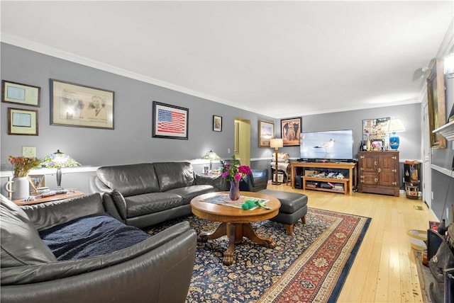 living room featuring hardwood / wood-style floors and ornamental molding