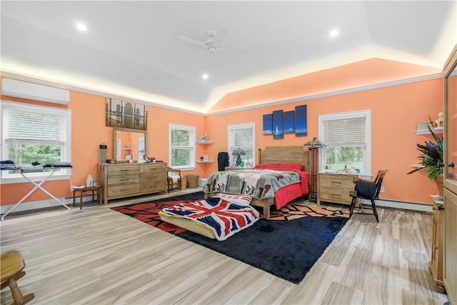 bedroom featuring light hardwood / wood-style flooring, vaulted ceiling, ceiling fan, baseboard heating, and a wall mounted AC