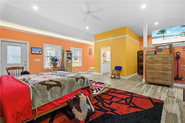 bedroom with ensuite bath, ceiling fan, and light wood-type flooring