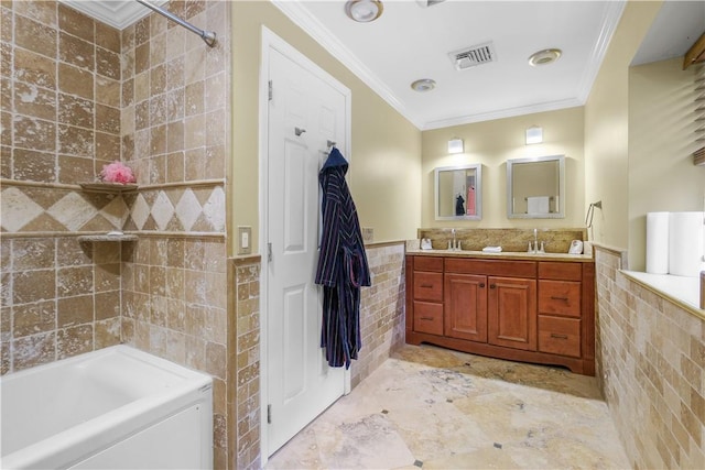 bathroom featuring vanity, tiled shower / bath combo, tile walls, and ornamental molding