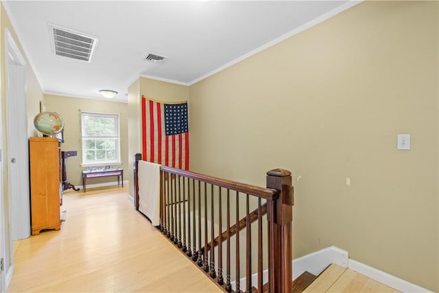 hallway featuring light hardwood / wood-style flooring and crown molding