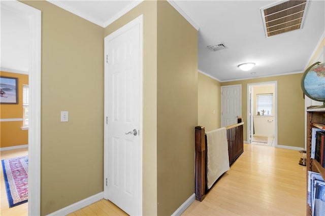 hall featuring light hardwood / wood-style floors and ornamental molding