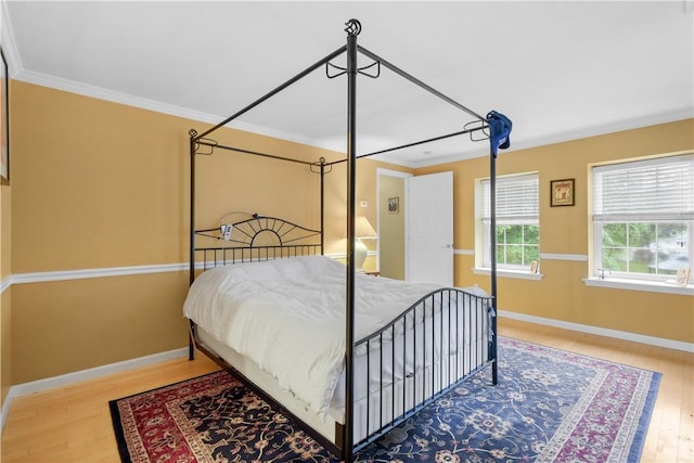 bedroom with hardwood / wood-style flooring and ornamental molding