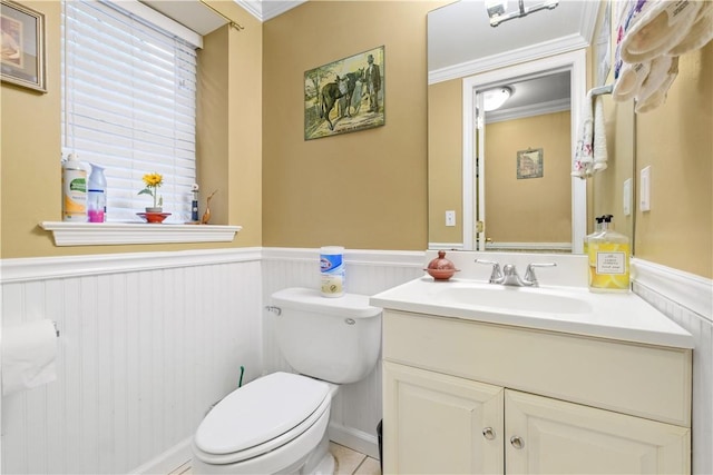 bathroom featuring tile patterned flooring, vanity, toilet, and crown molding