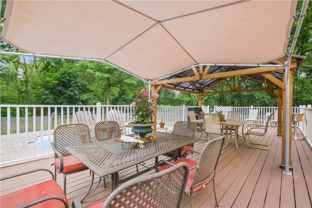 67 Myers Corners Rd, Wappingers Falls, NY 12590 - wooden terrace with outdoor dining space, a gazebo, and view of scattered trees
