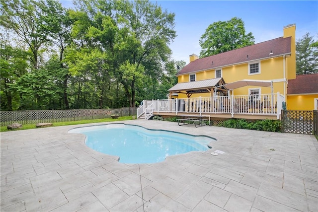 view of pool with a patio and a deck