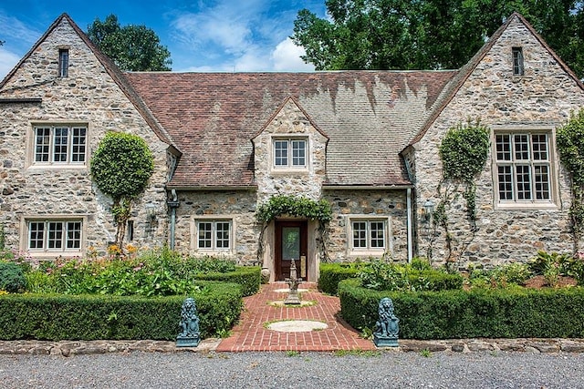 english style home featuring a patio area