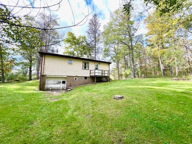 exterior space featuring a lawn and a wooden deck