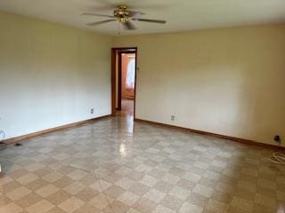 unfurnished room with ceiling fan