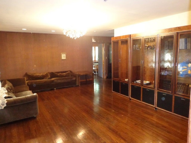 living room featuring dark hardwood / wood-style floors and a notable chandelier