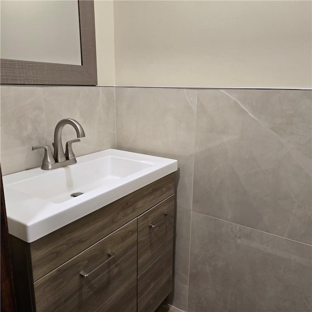 bathroom with tasteful backsplash, vanity, and tile walls