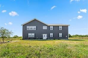 view of side of property with a yard