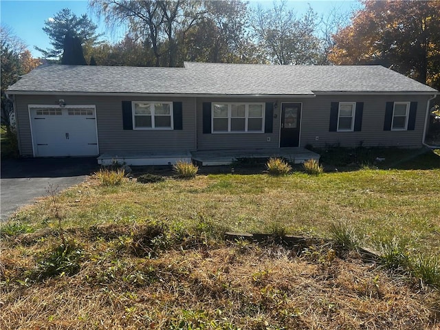 ranch-style house featuring a front lawn and a garage