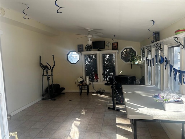 workout room featuring vaulted ceiling, tile patterned floors, and ceiling fan