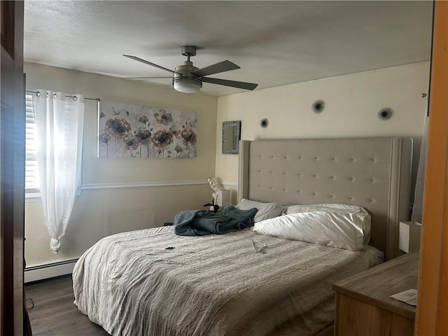 bedroom with ceiling fan, dark hardwood / wood-style flooring, and a baseboard radiator