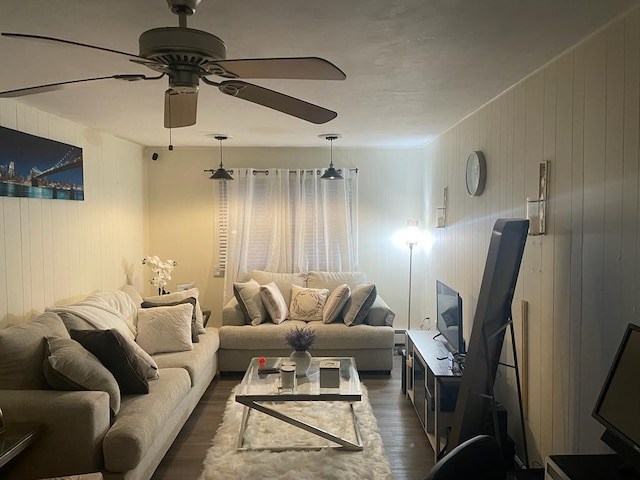 living area with dark wood-type flooring and a ceiling fan