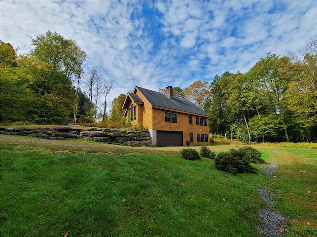 view of property exterior featuring a yard and a garage