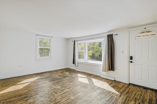 foyer featuring plenty of natural light, dark hardwood / wood-style floors, and a baseboard heating unit