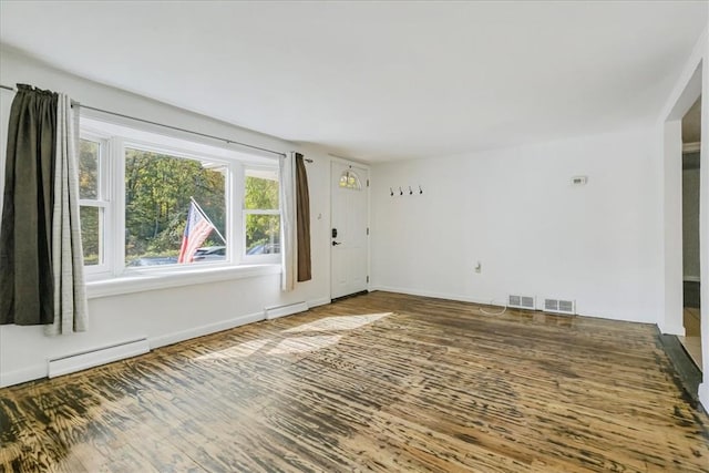 spare room featuring wood-type flooring and a baseboard radiator