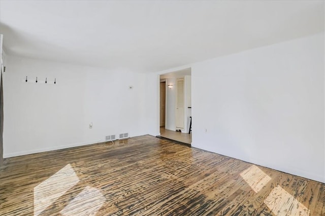 spare room featuring dark wood-type flooring