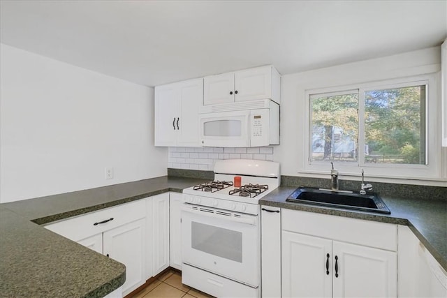 kitchen featuring white appliances, white cabinetry, and sink