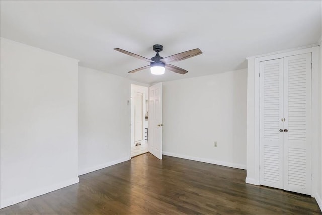 unfurnished room featuring ceiling fan and dark wood-type flooring