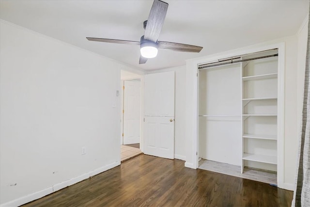 unfurnished bedroom featuring ceiling fan, a closet, and dark hardwood / wood-style floors